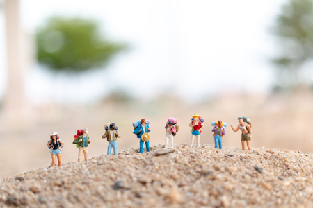 Miniature people : Traveler with backpack walking  on sand , Travel and Adventure concepts.の写真素材