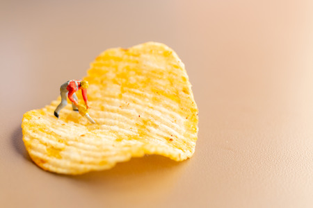 Miniature people : Worker are working with potato chipsの写真素材