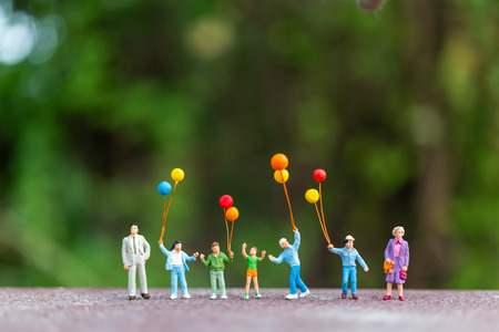 Miniature people : Happy family  holding colorful balloons ,   Happy family  Conceptの写真素材