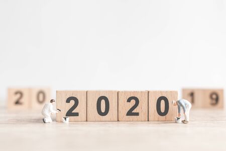 Miniature worker team painted number 2020 and remove number 2019  , Happy new year 2019 concept