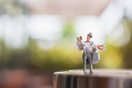 Miniature people : Bride and groom couple standing on The stage , Happy valentine's day conceptの写真素材