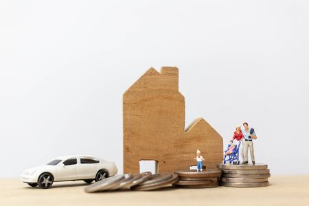 Miniature people : Parents with children with house and Coins Stacking  , Happy family conceptの写真素材