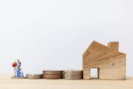Miniature people : Parents with children with house and Coins Stacking  , Happy family conceptの写真素材