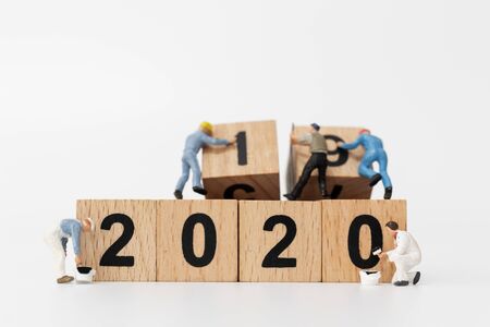 Miniature people : Worker team create wooden block number 2020  , Happy new year conceptの写真素材