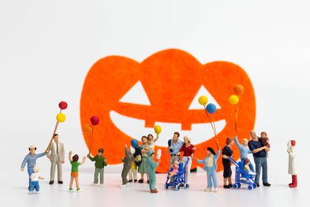 Miniature people:  Happy family holding balloon on white background Happy Halloween conceptの写真素材