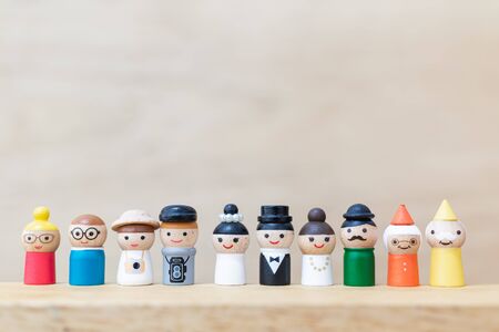 Miniature toy : Wooden doll with  happy face on wooden backgroundの写真素材