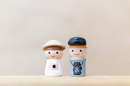 Miniature toy : Wooden doll with  happy face on wooden backgroundの写真素材