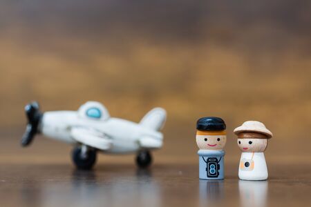 Miniature toy : Wooden doll with  happy face on wooden backgroundの写真素材