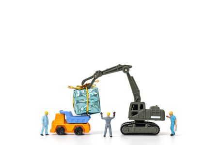 Miniature people working on a gift box, Christmas decoration conceptの写真素材