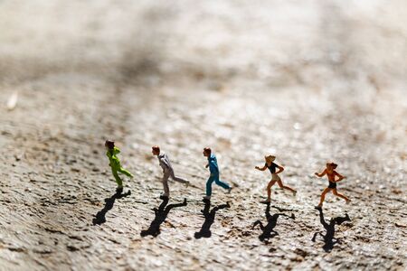 Miniature people : Group of people are running  on concrete floor,  Healthy and lifestyle conceptの写真素材