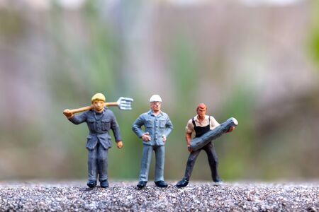 Miniature people , worker holding tools and copy space for your text , Labour day conceptの写真素材