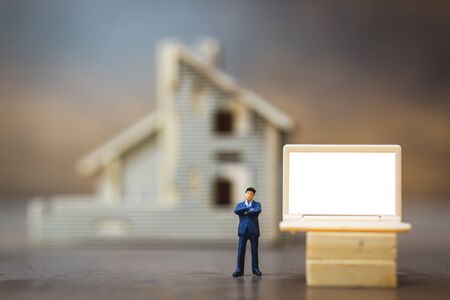 Miniature people business man working with computer labtop , Work at home conceptの写真素材