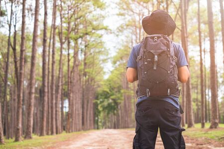 Asian man with backpack hiking in forest , Adventure Travel Remote Relax Conceptの写真素材