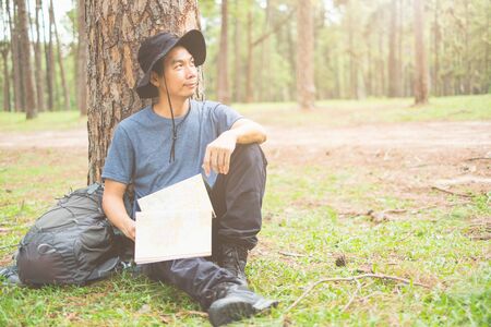 Asian man with backpack hiking in forest , Adventure Travel Remote Relax Conceptの写真素材