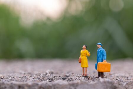 Miniature people , Traveler holding a handbag standing in the park , Travel conceptの写真素材