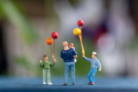 Miniature people: Happy family holding balloon in The park , Father's Day conceptの写真素材