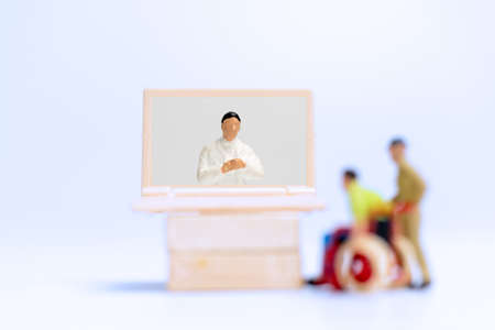 Miniature people , Male patient talk consult with doctor using video call on laptop , online doctor conceptの写真素材