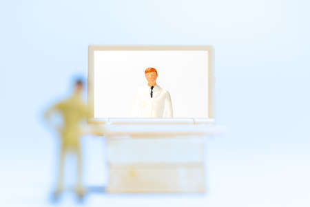 Miniature people , Male patient talk consult with doctor using video call on laptop , online doctor conceptの写真素材