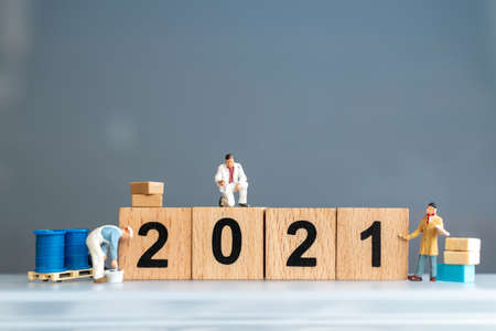 Miniature worker team painted number 2021 and remove number 2020 , Happy new year conceptの写真素材
