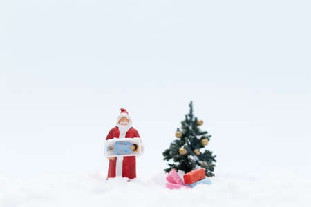 Miniature people, Santa claus and gifts for kid , Christmas and Happy New Year concept.の写真素材