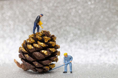Miniature people,  Worker team prepared a Christmas pine cone , Christmas and Happy New Year concept.の写真素材