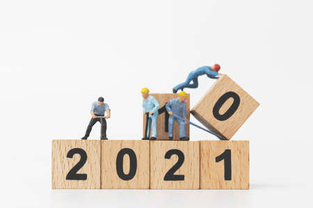 Miniature people : Worker team create wooden block number 2021  , Happy new year concept