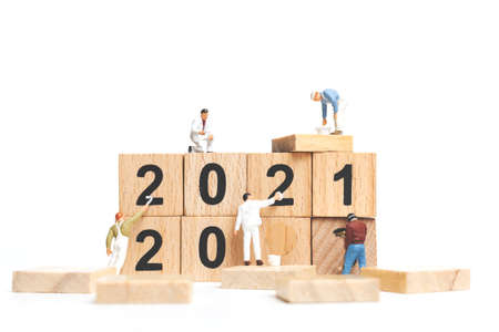Miniature people : Worker team create wooden block number 2021  , Happy new year conceptの写真素材