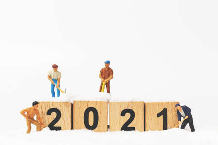 Miniature people : Worker team create wooden block number 2021  , Happy new year conceptの写真素材
