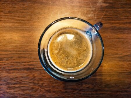 Top View Smoke on Coffee Cup With Wooden Table, Empty Space.