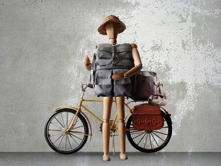 Wood Human Figure With Bicycle on Old Background, Travel Concept, Slow life, Empty Space, Front view, Funny Idea.の写真素材