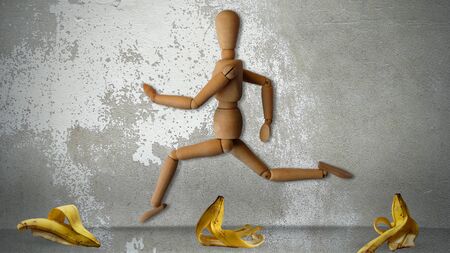 Wooden Human Jumping on Ground With Banana Peel, Wooden Human Running on Ground, Walking, Accident and Insurance Concept, Insurance, Accident, Funny Idea,の写真素材
