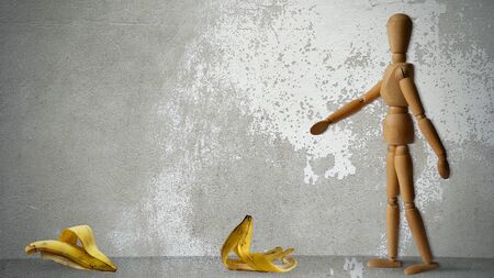Wooden Human Walking  on Ground With Banana Peel, Wooden Human Running on Ground, Walking, Accident and Insurance Concept, Insurance, Accident, Funny Idea,の写真素材