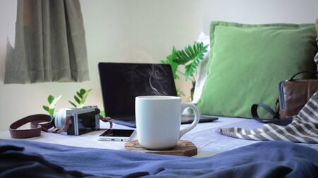 Smoke on Coffee Mug With Laptop Computer and Camera in Room, Working at Home Concept, Working, Thinking, Stay at Home,の写真素材