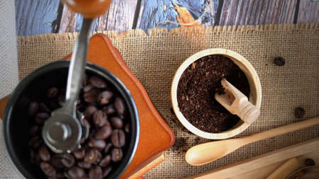 Top View Coffee Grinder Manual With Coffee Cup and Bean on Hemp Sack Background, Coffee Ingredients Conceptの写真素材
