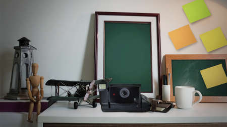 Front View Retro Camera With Photo Frame on Table, Working Tableの写真素材