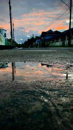 rain puddle on the road at twilight time in Bangkok, Thailandの写真素材
