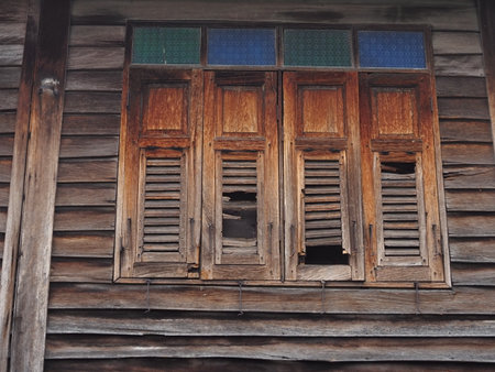 Old wooden window with shutters in the old house, Thailand.の写真素材