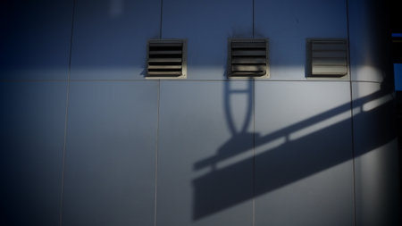 The shadow of the sun on the facade of a modern building.の写真素材