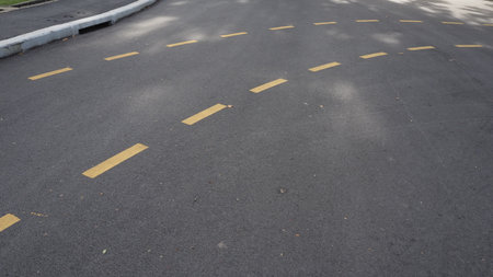 Asphalt road with yellow line for background and texture, stock photo