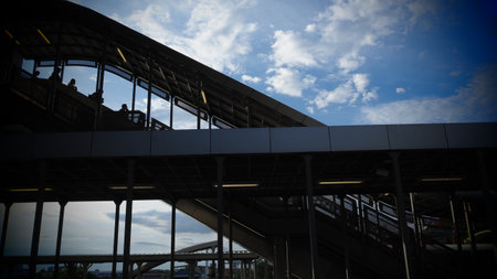 Modern building with blue sky and white clouds, view from below.