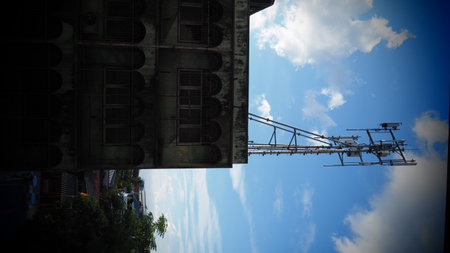 Crane and building under construction with blue sky in Bangkok, Thailand