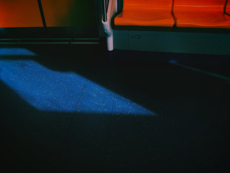 Interior of an empty subway station with orange seats and blue floorの写真素材