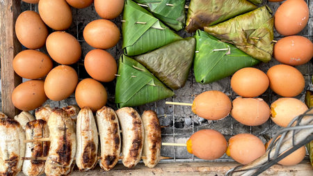 Grilled bananas with eggs and banana leafs on the grill.の写真素材