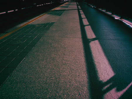 Railway station at night with shadow on the ground. Toned.の写真素材