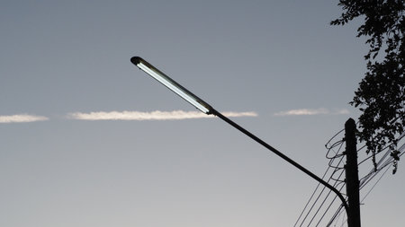 street lamp on a background of blue sky with white clouds in the eveningの写真素材