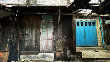 Old wooden house with blue door and windows in Bangkok, Thailand.の写真素材