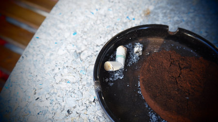 Cigarette butts in ashtray, filter applied.の写真素材