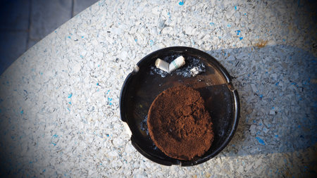 Cigarette butts in ashtray, filter applied.の写真素材