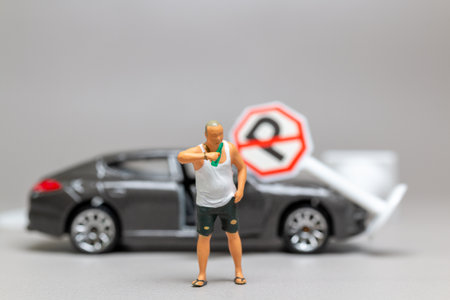 Miniature people, A Drunk driver holding a liquor bottle as he steps out of a car. concepts of reckless behavior, urban lifeの写真素材