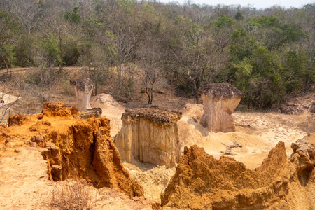 Stunning rock formations at Phae Mueang Phi Forest Park in Phrae, Thailand. A unique geological wonder with rugged sandstone pillars shaped by natural erosion.の写真素材